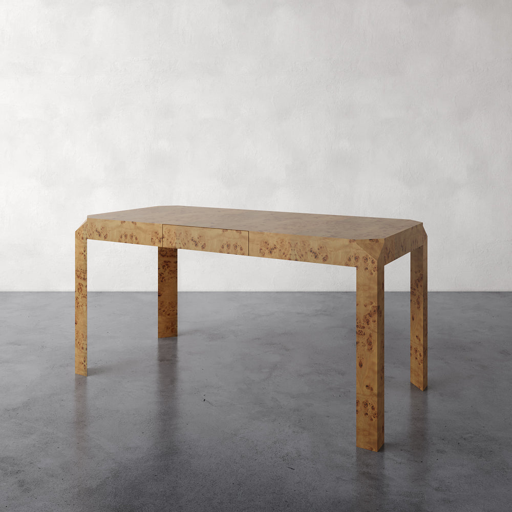 Lemieux et Cie Armand Desk in hand-matched burl veneer, sculptural desk with hidden drawer, shown on concrete floor against neutral walls.