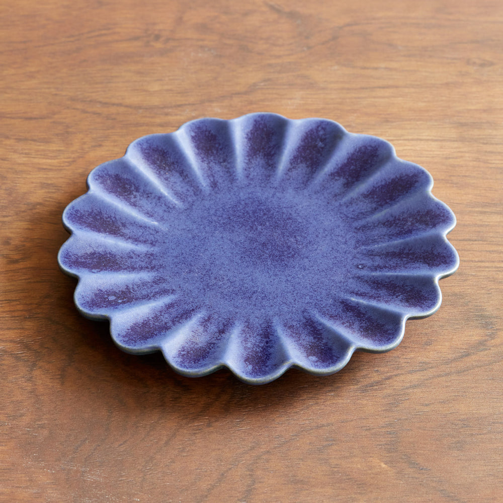 Lemieux et Cie Dhalia Stoneware Salad Plate in blue with scalloped edges, ceramic dinnerware shown on warm wood surface.