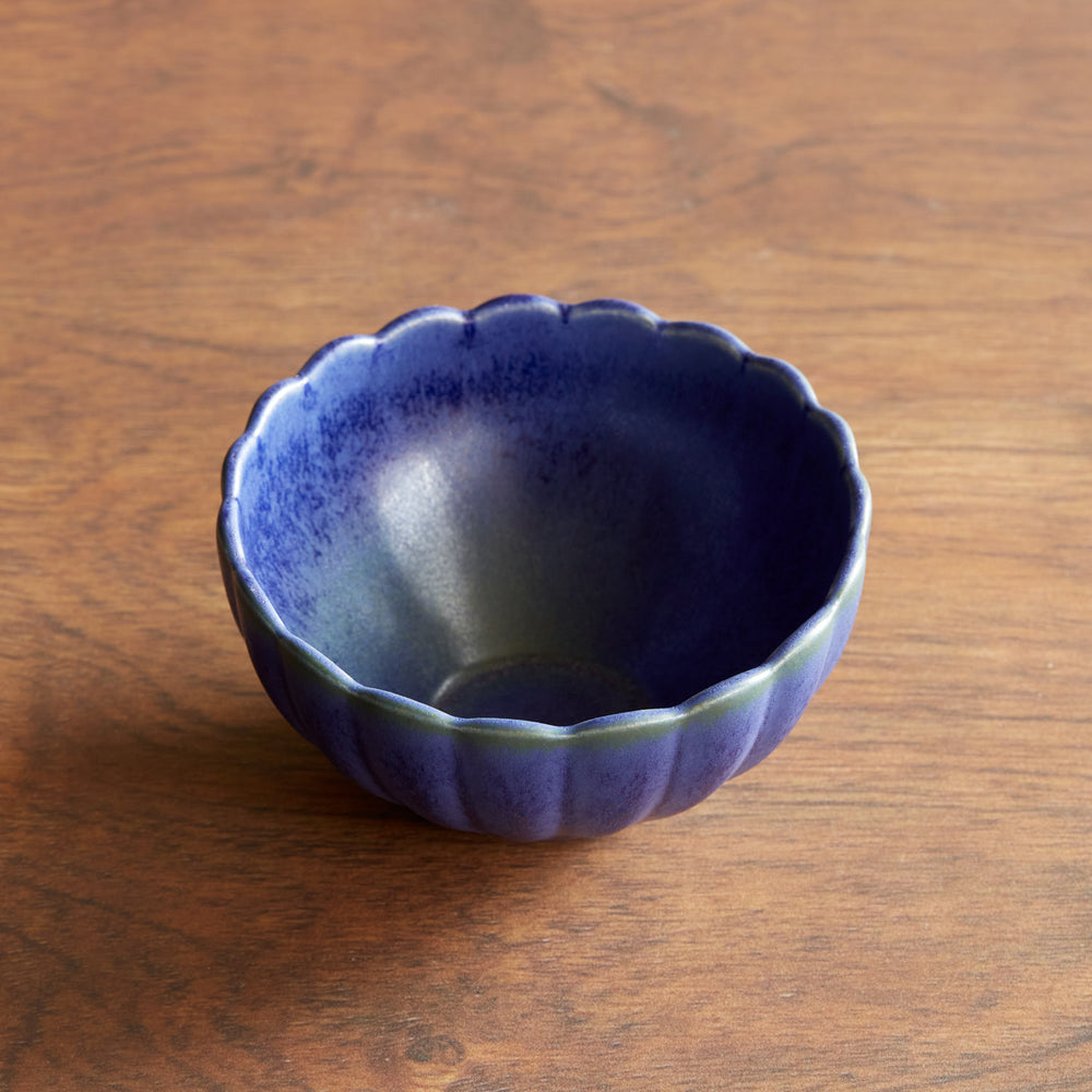Lemieux et Cie Dhalia Stoneware Bowl in blue ceramic with scalloped rim, small serving bowl shown on warm wood surface.