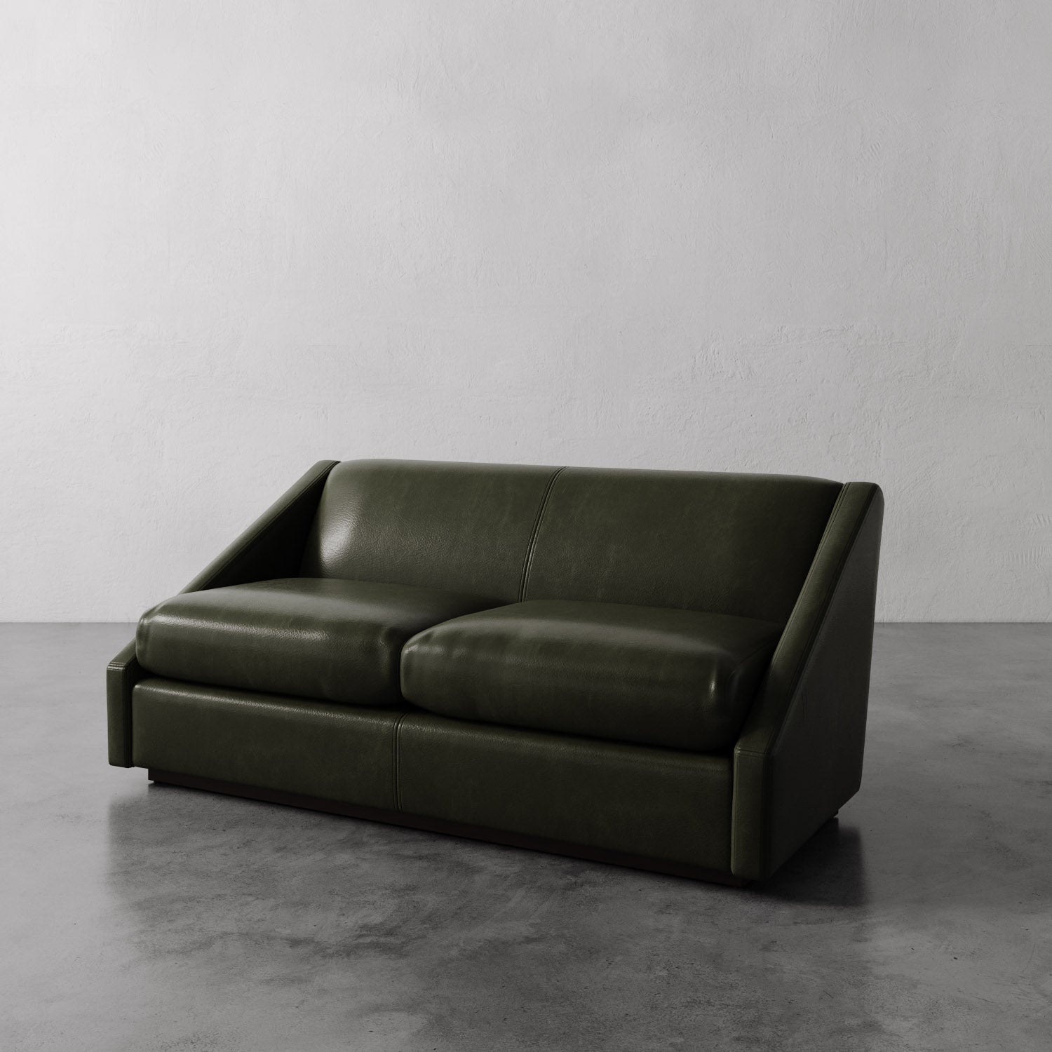 Lemieux Et Cie dark green Fontaine Leather Sofa on a gray floor with a plain white wall background