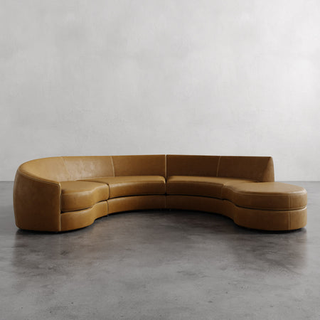 Lemieux et Cie Rulmann 4-Piece Left Sectional in warm tobacco, curved modular sofa with organic rounded form, shown on polished concrete floor.
