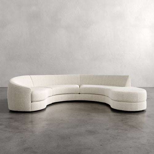 Lemieux Et Cie Rulmann 4-Piece Left Sectional Curved beige sofa against a plain gray wall