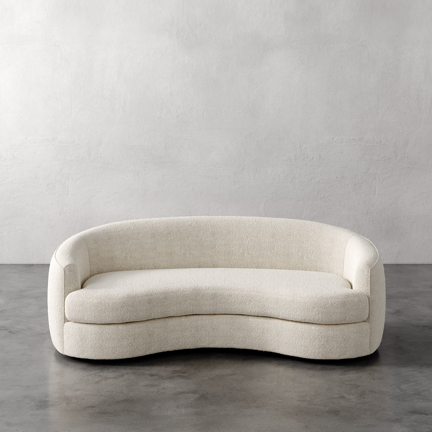 Lemieux Et Cie Rulmann Sofa Beige curved sofa against a plain gray wall