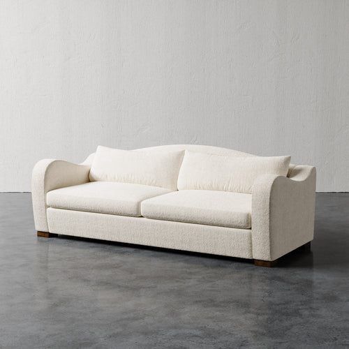 Lemieux Et Cie Elodie Sofa (Made-to-order) White sofa on a gray floor with a plain white wall background