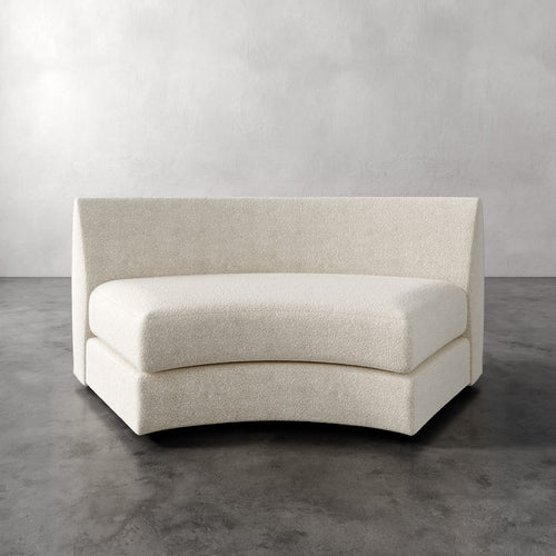 Lemieux Et Cie Rulmann Wedge Beige curved sofa against a plain background
