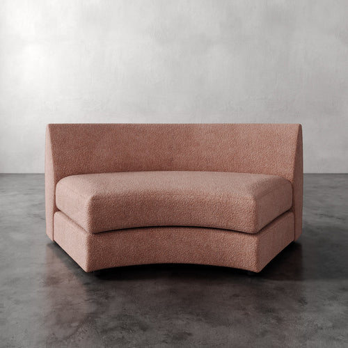Lemieux Et Cie Rulmann Wedge Pink sofa against a gray wall