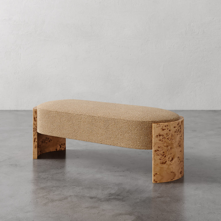 Lemieux et Cie Benoit Upholstered Bench in textured neutral bouclé with curved Maple burl legs, shown on concrete floor against neutral walls.