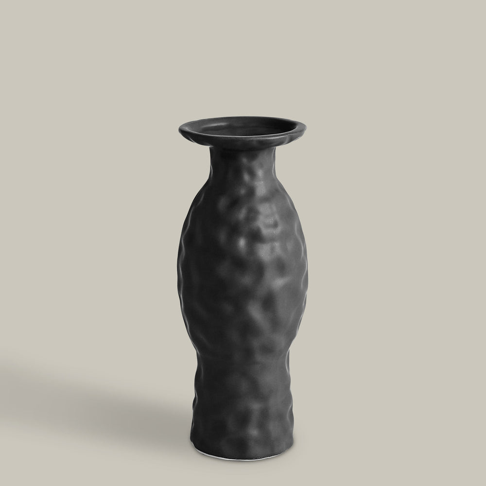 Lemieux et Cie Volcanic Vase, sculptural dark vase with organic textured surface and flared rim, shown on neutral backdrop.