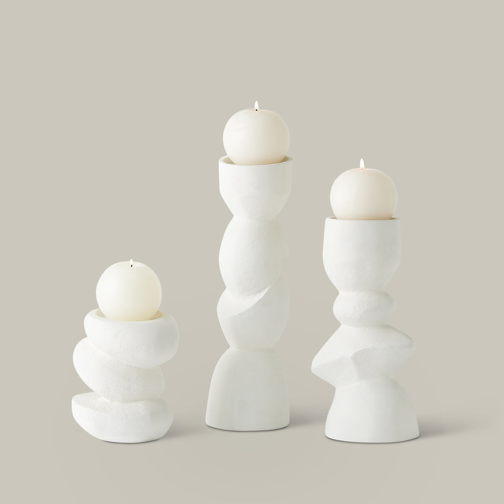 Lemieux et Cie sculptural candle holders in white, stacked organic forms with sphere candles, shown on neutral studio backdrop.