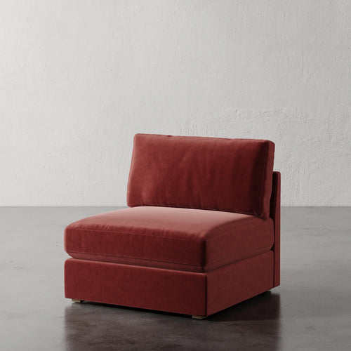 Lemieux Et Cie Chanaux Armless Chair
Red velvet armchair on a gray floor with a white textured wall background