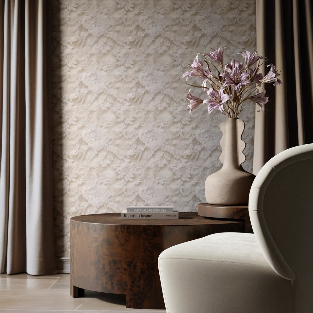 Lemieux et Cie Rondel Bunching Cocktail Table in mappa burl, drum-shaped low table styled beside upholstered chair against textured neutral wallpaper and soft drapery.