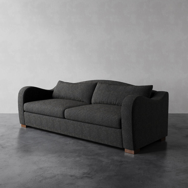 Lemieux Et Cie beige Elodie sofa with a deep seat, soft back cushion, and swooping arms in Charcoal Performance Bouclé