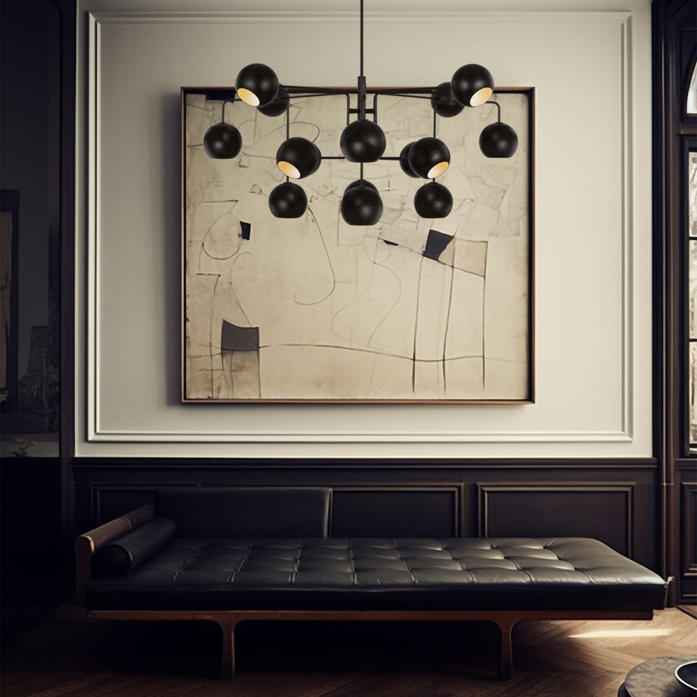 Lemieux et Cie Chaumont 16 Light Extra Large Chandelier in aged iron, a luxury lighting fixture above layered seating, artwork, and warm tones in a balanced interior.