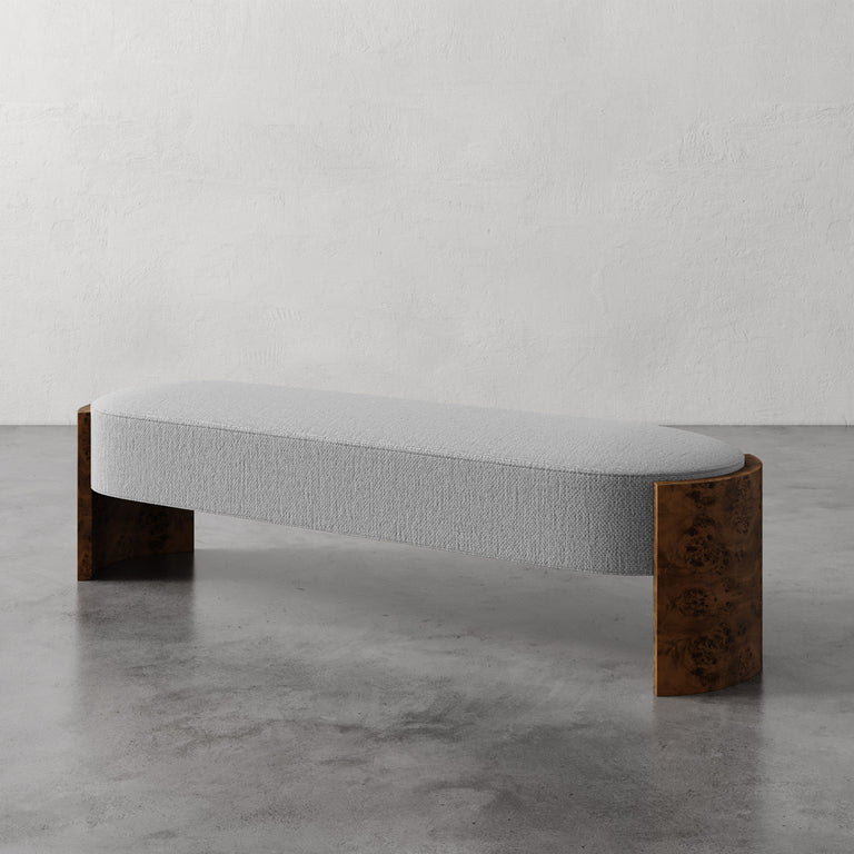 Lemieux et Cie Benoit Custom Upholstered Bench with curved Maple burl legs and light gray upholstered seat, shown on polished concrete floor.