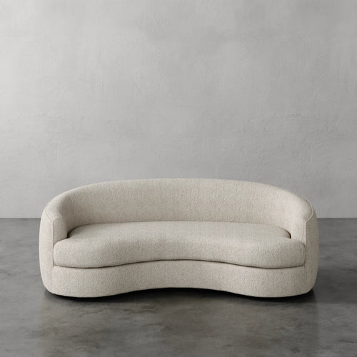 Lemieux Et Cie Rulmann Sofa Beige curved sofa against a gray wall