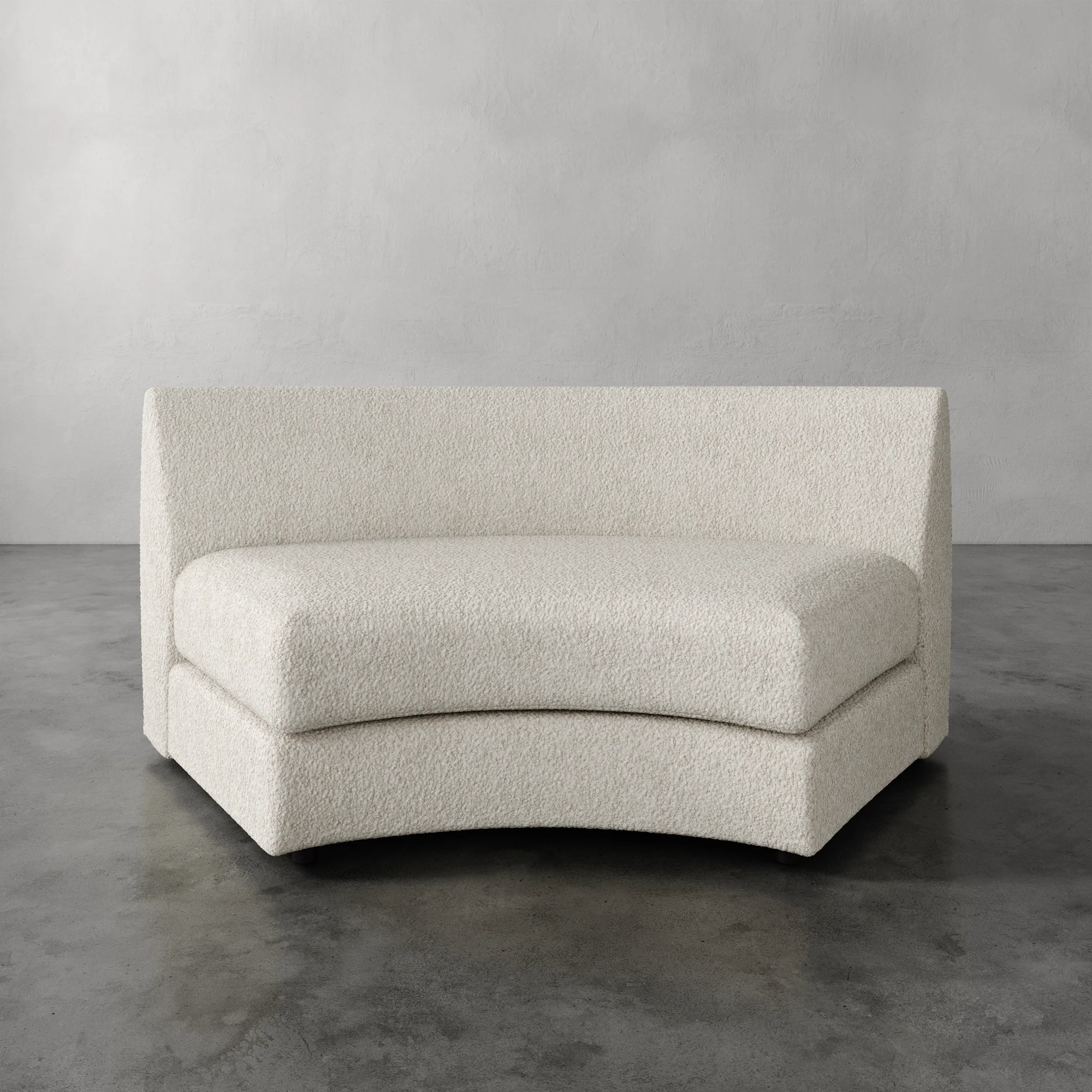 Lemieux Et Cie Rulmann Wedge Curved beige sofa against a gray background
