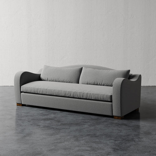 Lemieux Et Cie Elodie Sofa - Bench Seat (Made-to-order) Gray sofa in a minimalistic room with a plain wall and floor.