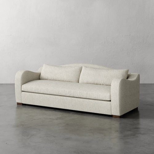 Lemieux Et Cie Elodie Sofa - Bench Seat (Made-to-order) Beige sofa on a gray floor with a plain gray wall background