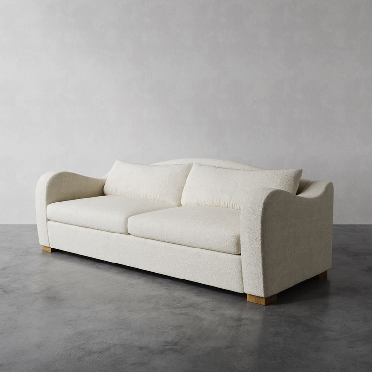 Lemieux Et Cie beige Elodie sofa with a deep seat, soft back cushion, and swooping arms in Cream Performance Bouclé