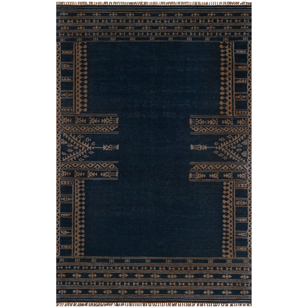 Lemieux et Cie Duar Carpet in deep indigo with geometric border motifs, space-dyed rug with fringe detail, shown on white studio backdrop.