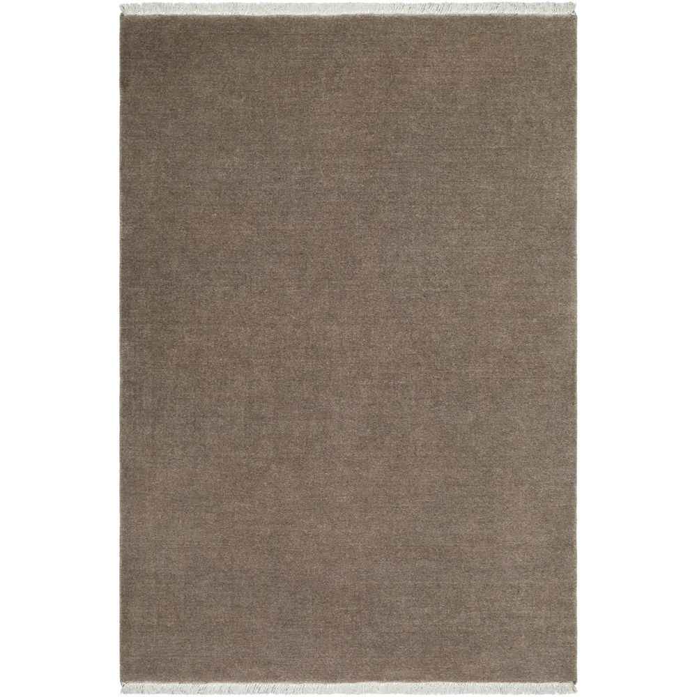 Lemieux et Cie Plume Handmade Wool Rug in taupe, handloomed solid with fringe detail, shown on white studio backdrop.
