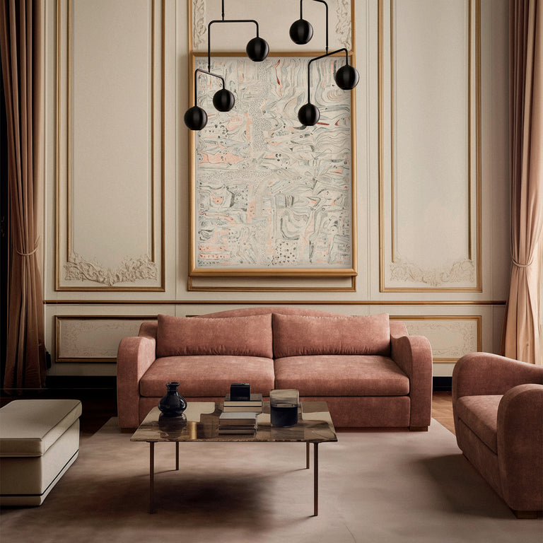Lemieux Et Cie Elodie sofa and chair in pink, paired with Les Terrains Londres Art Print, coffee table and Chaumont chandelier, set in a classic neutral-toned living room.