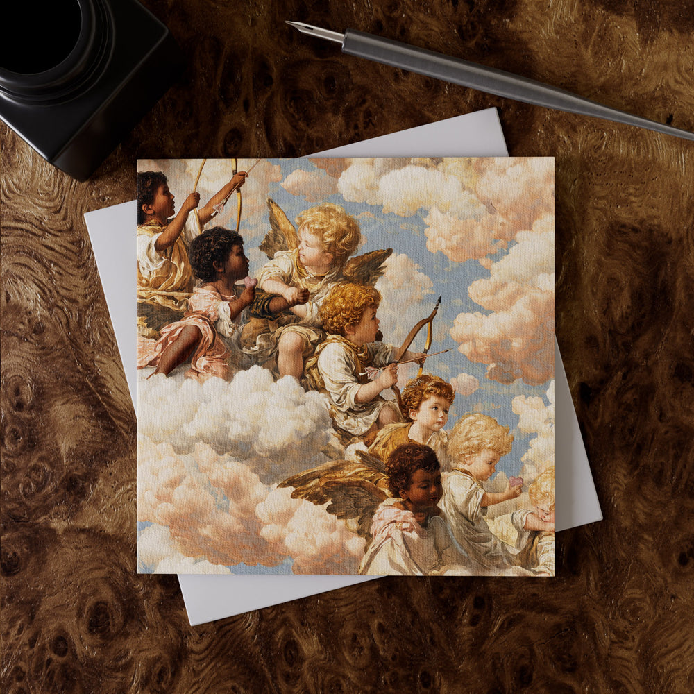 Lemieux et Cie Grecian Cherub Greeting Card Set printed on fine art linen paper, shown on richly grained wood surface with white envelope and pen.