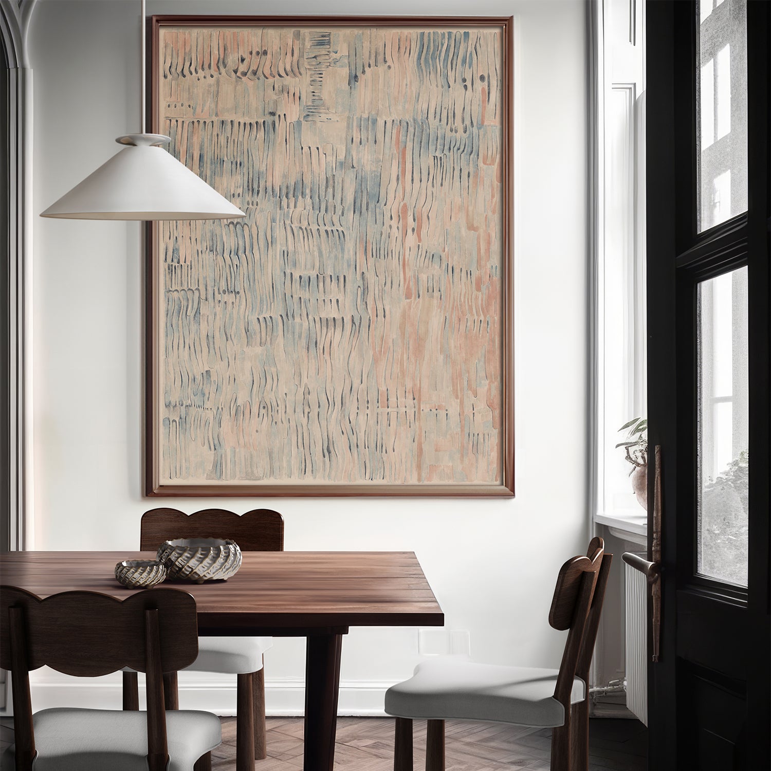 Lemieux et Cie Étretat Limited Edition Art Print in neutral tones, framed artwork above a dining table with dark chairs in a white-walled room with soft daylight.