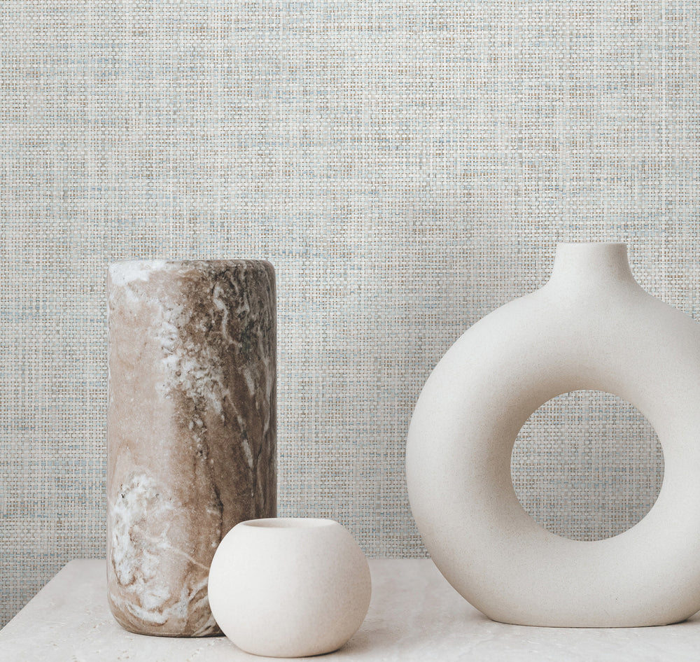 Lemieux et Cie Kami Paperweave in sky blue, material swatch, shown as textured backdrop with sculptural ceramic vases on marble surface.