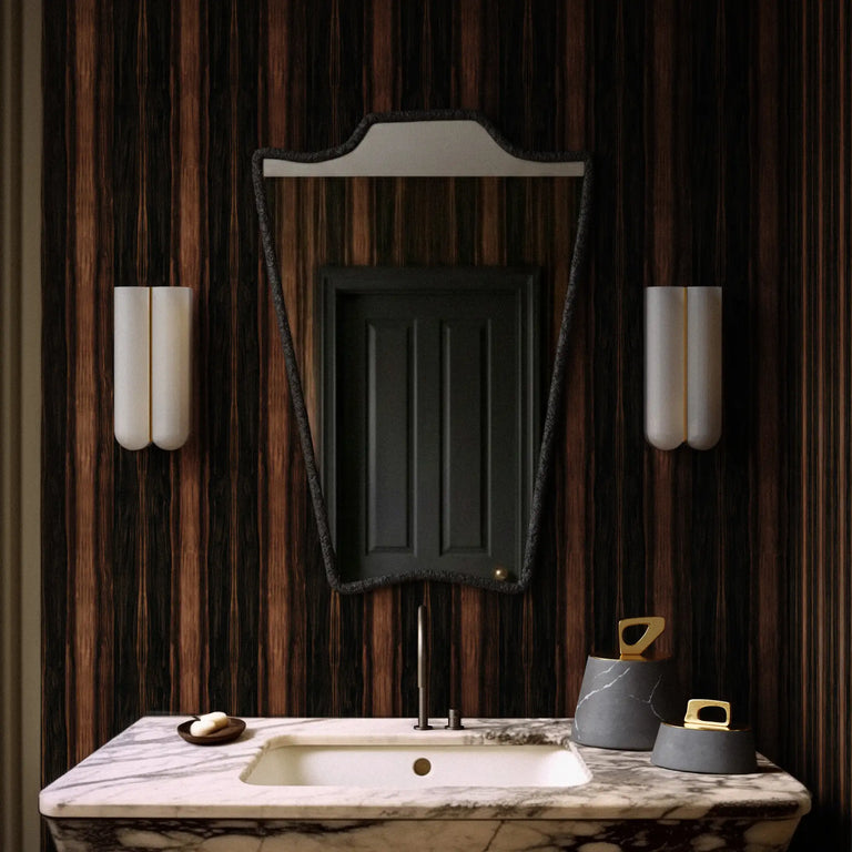 Bathroom vanity with marble countertop, sink, and Lemieux et Cie Grand Panel Macassar Wood peel and stick wallpaper featuring bold ebony striping and high-contrast brown grain in a vertical panel effect.