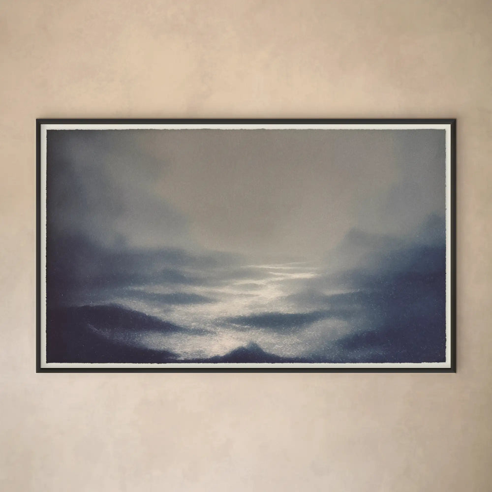 Lemieux et Cie Honfleur Limited Edition Art Print, atmospheric seascape in deep blue and gray tones, framed in dark wood on neutral plaster wall.