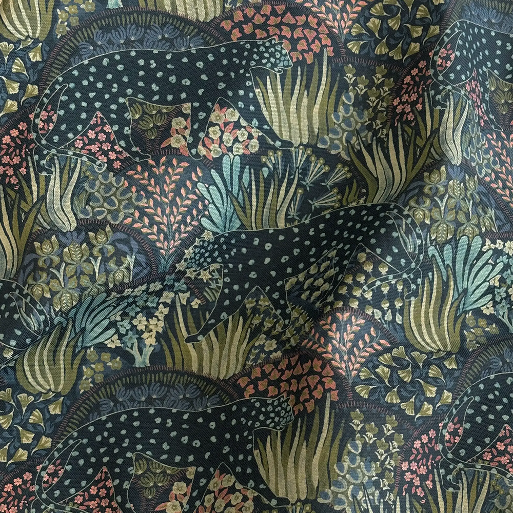 Lemieux et Cie Outdoor Pillow in Leopard Floral pattern, decorative pillow swatch showing dark spotted leopards amid coral, sage and aqua botanical motifs.