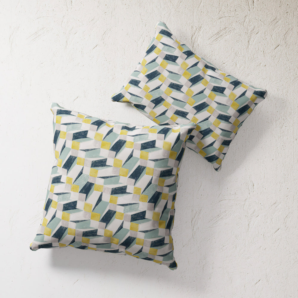 Lemieux et Cie Outdoor Pillow in Op Art Blue geometric pattern, pair of square pillows shown on textured plaster surface