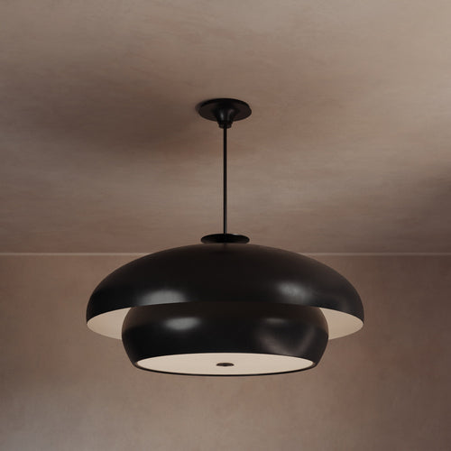 Lemieux et Cie Solene Chandelier in dark matte finish, sculptural dome-shaped pendant light illuminated against neutral plaster ceiling in soft warm light.