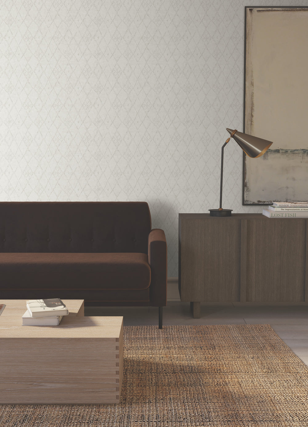Lemieux et Cie Souk Diamonds in cotton white with gray smoke, handpainted wallcovering with diamond pattern, shown in sitting room with dark sofa and natural woven rug.