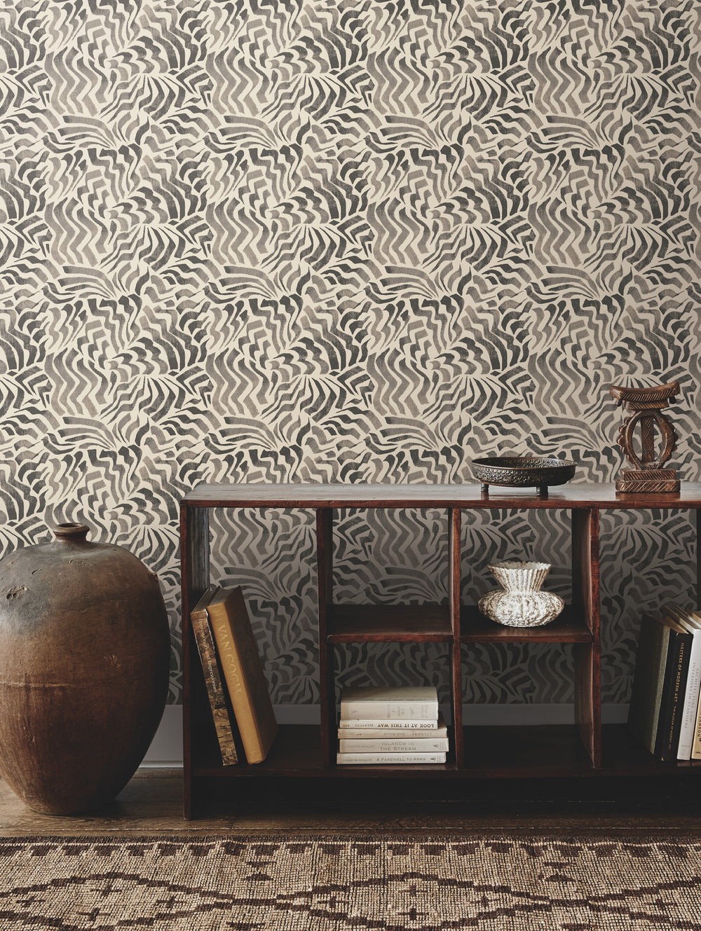 Lemieux et Cie Kami Paperweave in mushroom brown, handcrafted weave wallcovering with organic zigzag pattern, shown with low shelving and woven rug