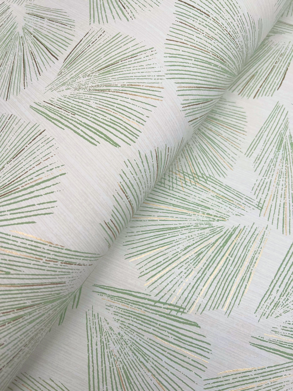 Lemieux et Cie Avril Chinoiserie in blush pink on dove gray, wallpaper with flowering branch motif, shown in soft draped folds on white studio backdrop.