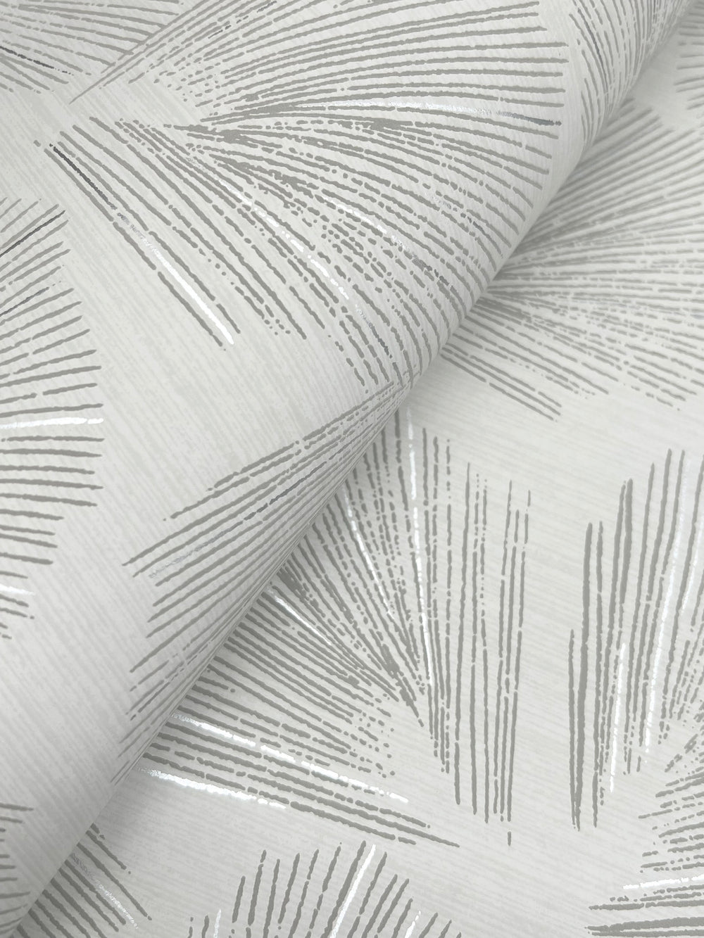 Lemieux et Cie Elora Leaf wallpaper in graphite gray with metallic, botanical pattern with fan-shaped leaves and raised veining, detail shot showing texture and dimensionality.