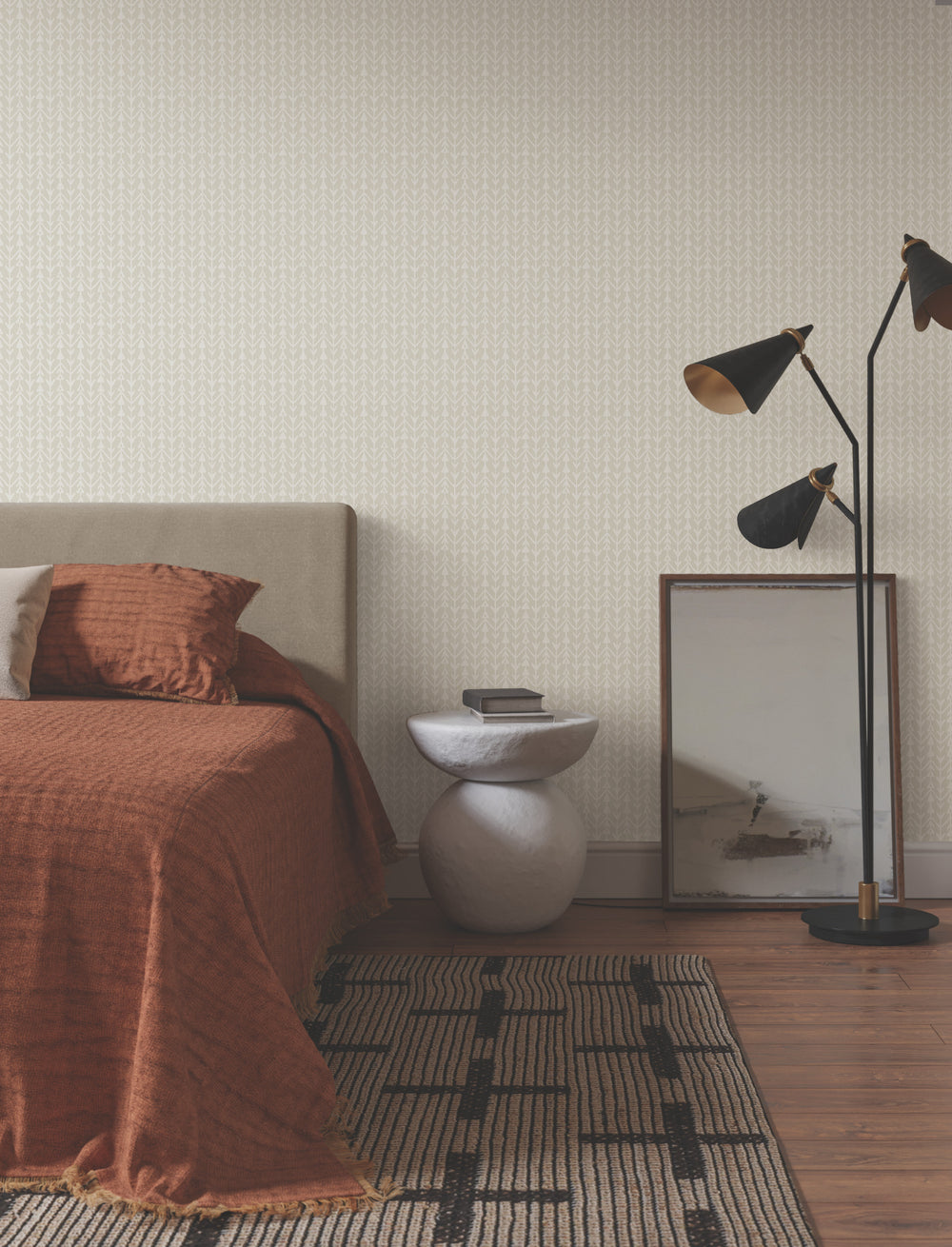 Lemieux et Cie Martigue Stripe rug in French gray, striped flat-weave carpet shown bedside on wood flooring in a neutral bedroom with warm textiles.