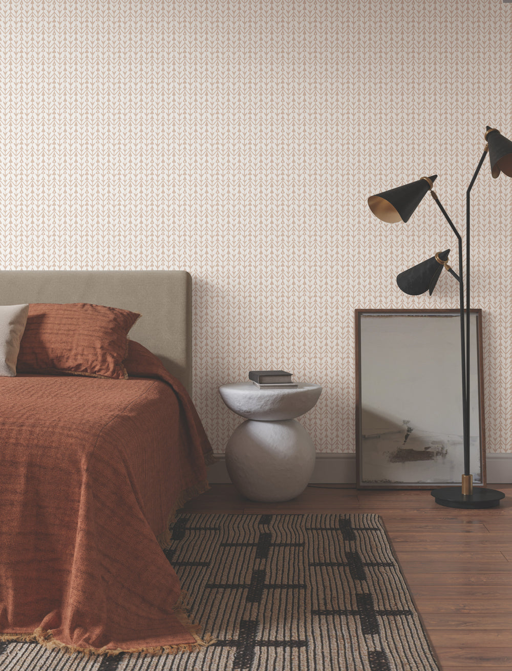 Lemieux et Cie Martigue Stripe in blush pink, striped rug shown bedside on wood flooring with patterned wallpaper and warm copper linens.