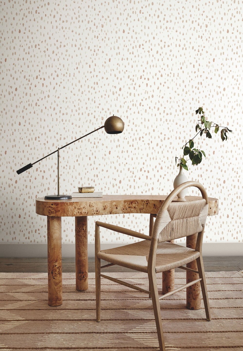 Lemieux et Cie Tachette Wallpaper in charcoal gray on parchment beige, watercolor brushstroke pattern, shown in sitting room with burl wood desk and woven chair on neutral rug.