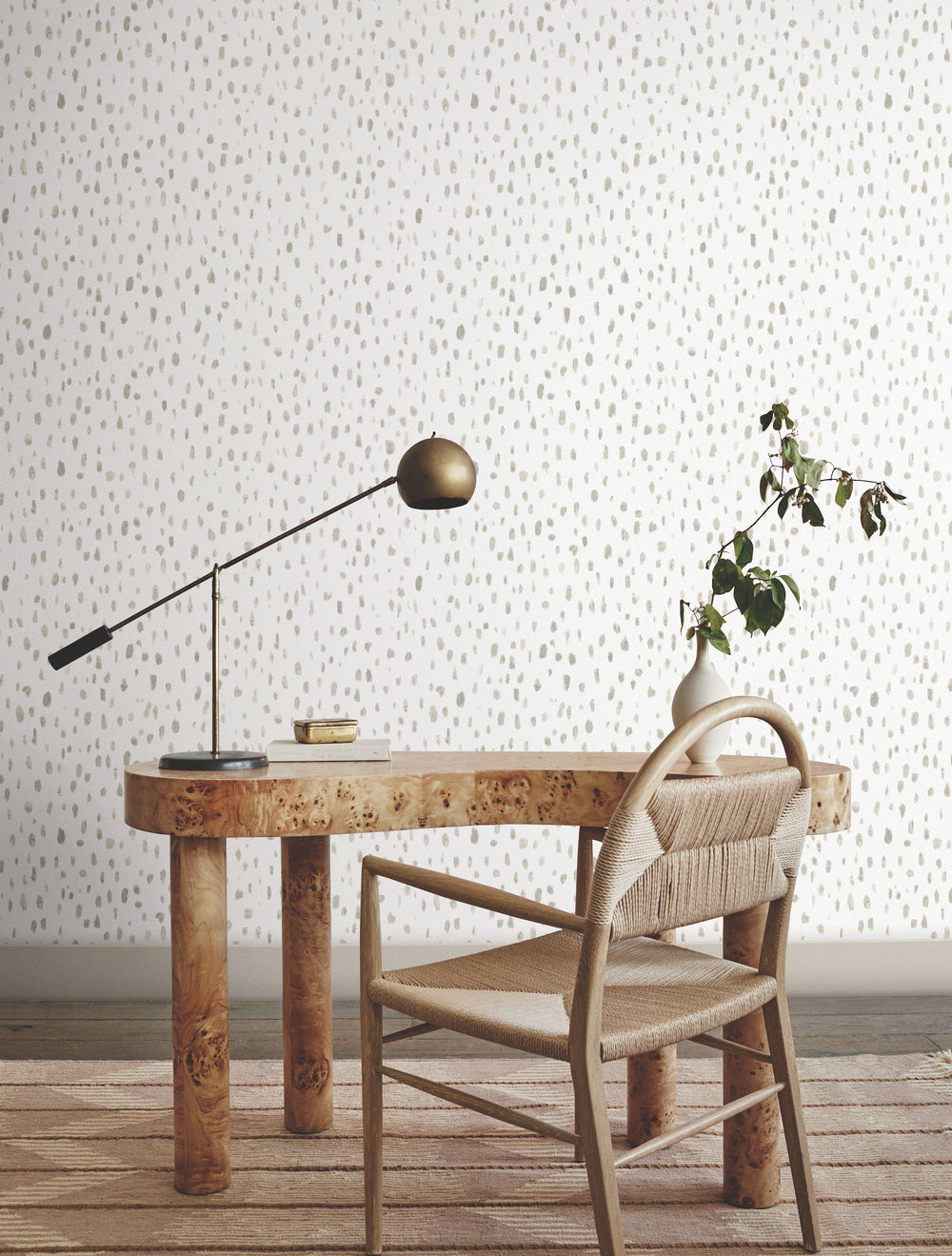 Lemieux et Cie Tachette Wallpaper in sky blue on white, watercolor brushstroke pattern, shown in a sitting room with burl wood desk, woven chair, and task lamp.