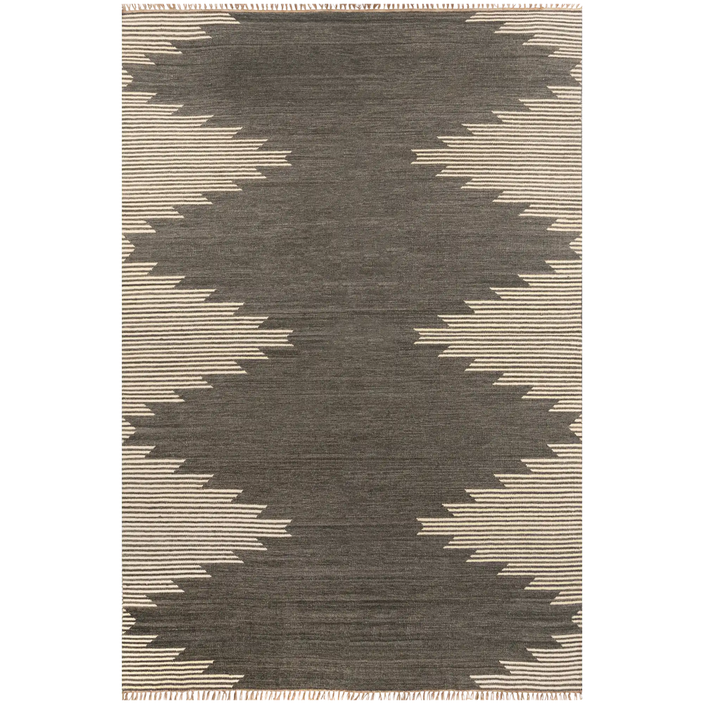 Lemieux et Cie Metlili rug in charcoal and ivory handwoven wool, geometric pattern with irregular striped border, shown on white studio backdrop.