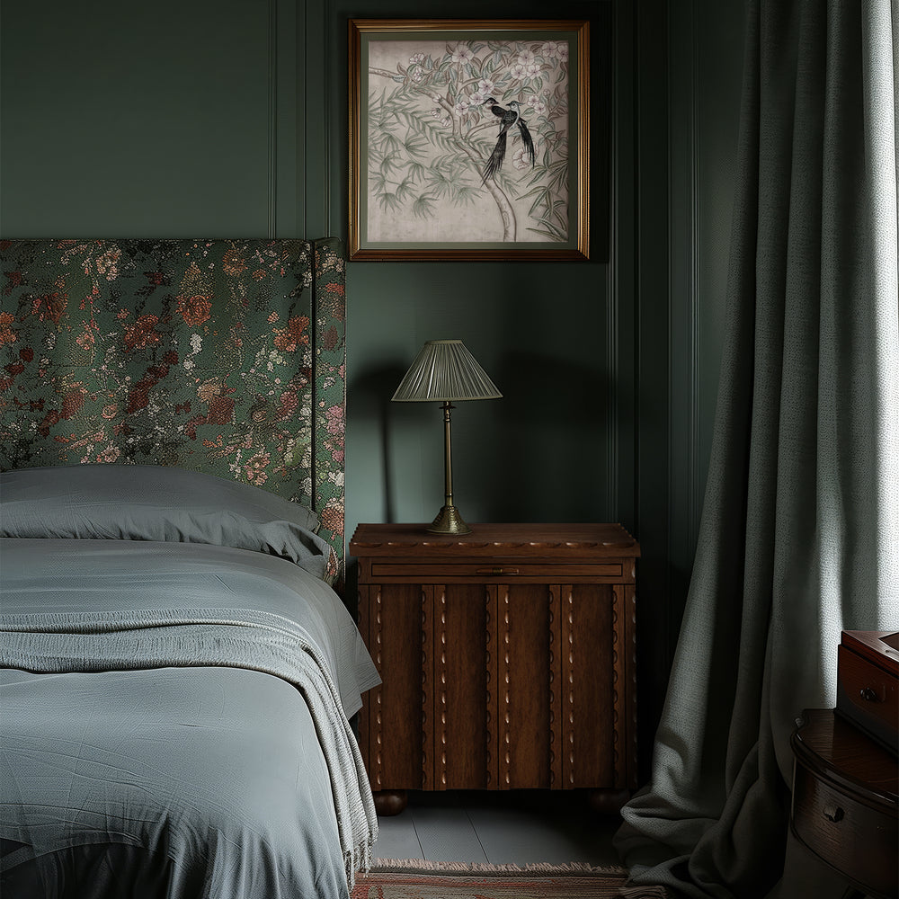 Lemieux et Cie Marchand Nightstand in oak with scalloped detailing, bedside table styled in bedroom with deep green paneled walls and floral upholstered headboard.