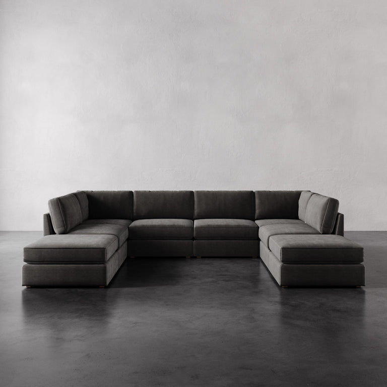 Lemieux Et Cie Chanaux 8-Pc Sectional
Gray sectional sofa on a concrete floor with a plain wall background