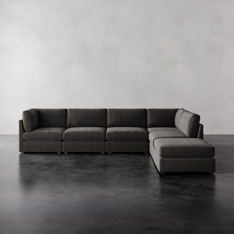 Lemieux Et Cie Chanaux 6-Pc Sectional
Gray sectional sofa in a minimalistic room with a plain wall and floor.