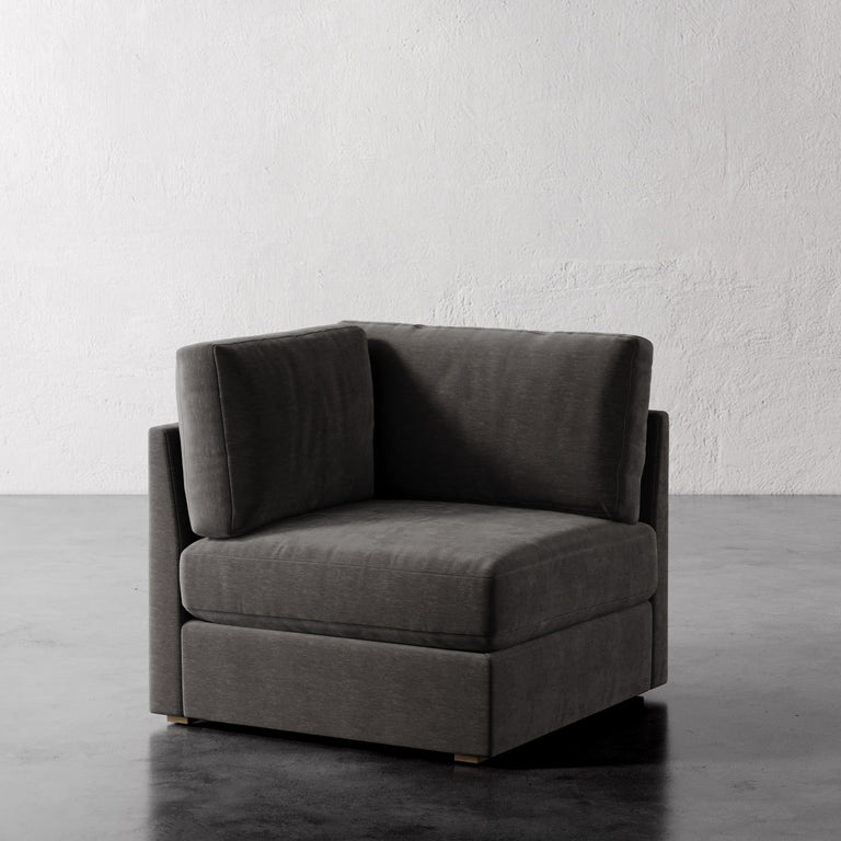 Lemieux Et Cie Chanaux Corner Chair Gray corner sofa against a white wall