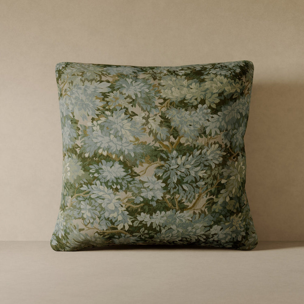 Lemieux et Cie Verdure Velvet Pillow with layered green and blue botanical motif, decorative pillow shown against neutral plaster wall.