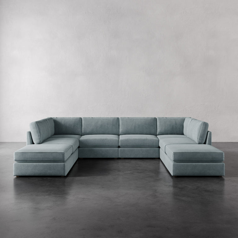 Lemieux Et Cie Chanaux 8-Pc Sectional
Light blue sectional sofa on a gray floor with a plain gray wall background