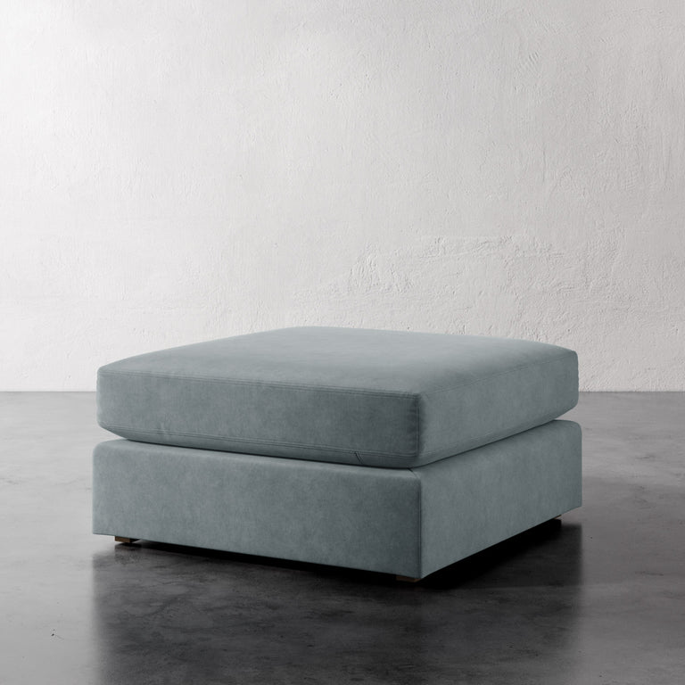 Lemieux Et Cie Chanaux Ottoman
Gray ottoman on a reflective surface with a white wall background